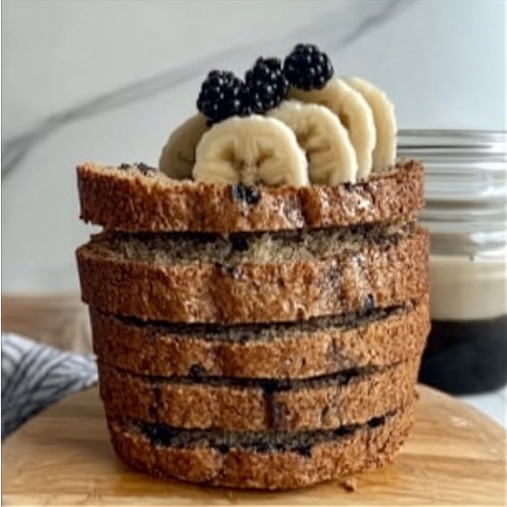 Freshly baked vegan banana bread loaf with slices, showcasing moist texture and dairy-free ingredients.4